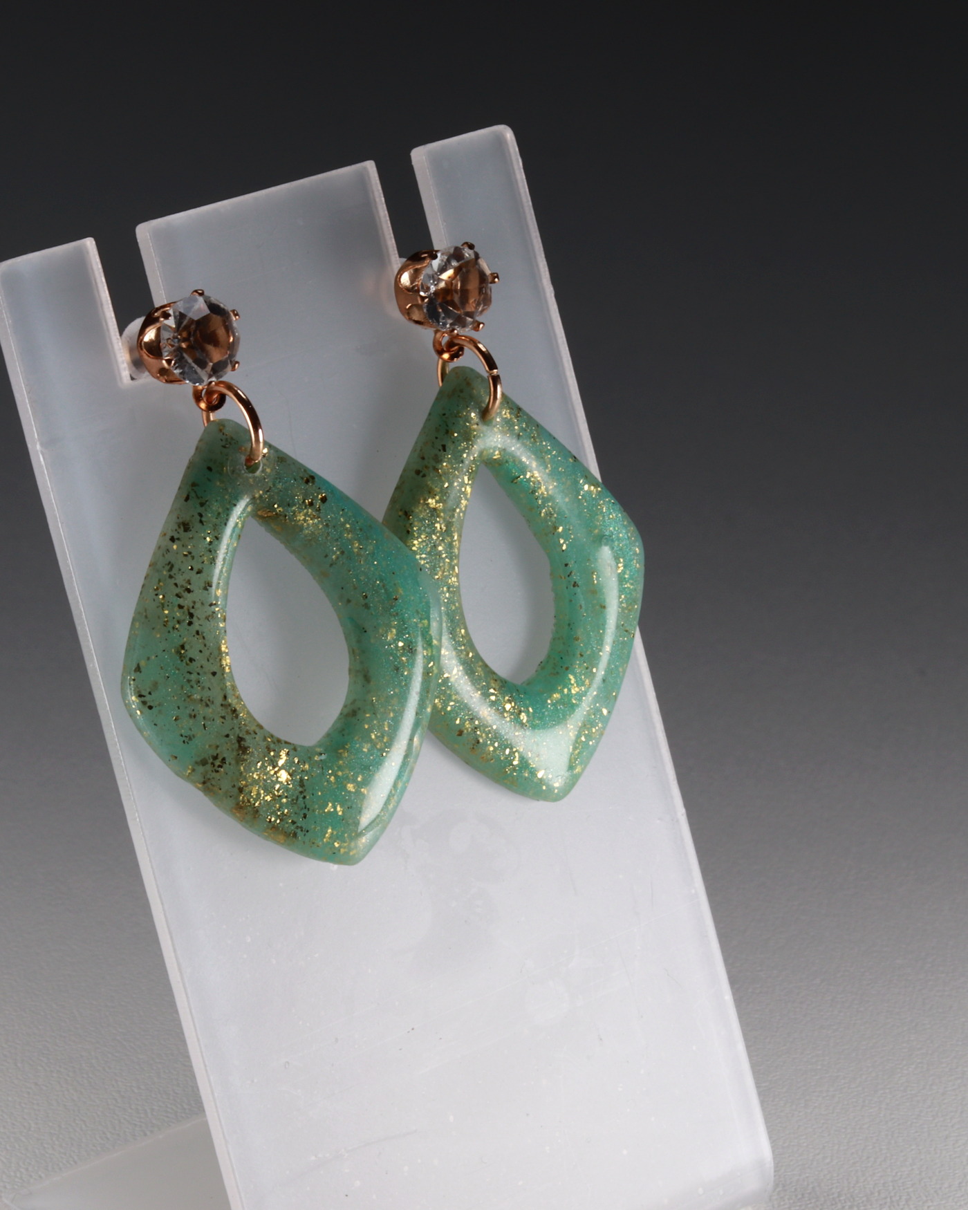 Turquoise marbled earrings shown in motion and pair balance